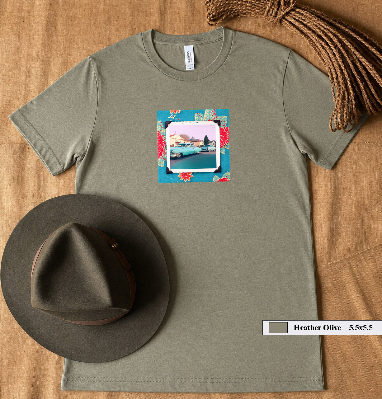 A hat and  t-shirt with a patch on the front of a vintage photo of two classic 50's cars.