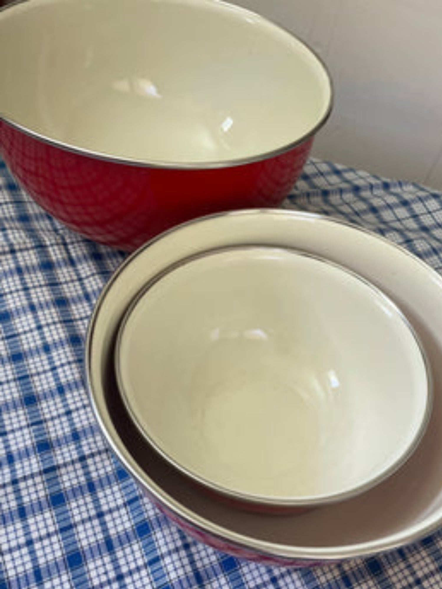 Set of bright red enamel bowls for kitchen decoration and use