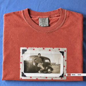 Brick colored folded t-shirt with a vintage 1930's snapshot of a boy and his holster in front of an old car.