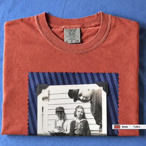 Brick colored folded t-shirt with large black and white vintage 1920's photo of kids posing for a shot