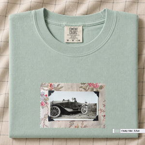 Chalky Mint colored folded t-shirt with small vintage snapshot of people riding in a 1920's car surrounded by a floral design.