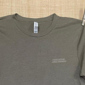 Close up shot of collage art t-shirt with tagline on front: 'Everlasting Agile Moments' 