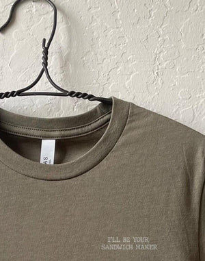Close up shot of collage art t-shirt with tagline on front: 'I'll Be Your Sandwich Maker'
