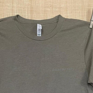 Close up shot of collage art t-shirt with tagline on front: 'Irresistibly Tasty' 