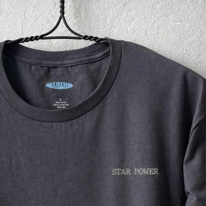 Close up shot of collage art t-shirt with tagline on front: 'Star Power'