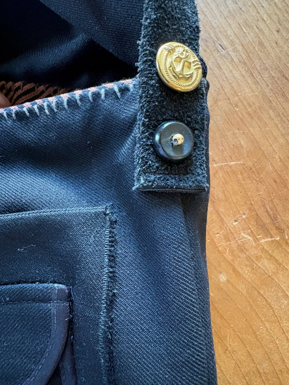Front of a bag made from a US Navy uniform shirt and suede strap.