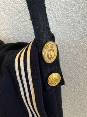 Close up view of authentic Navy vbottons and suede strap on a vintage sailer collar bag