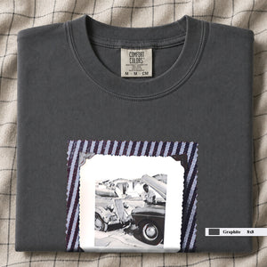 Folded Graphite  t-shirt with a large vintage photo of mechanics and cars on front of shirt.