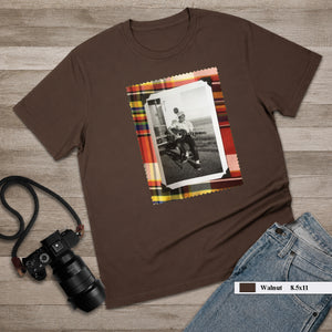brown tee shirt on table with large vintage photo of guitar player