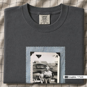 Graphite colored folded t-shirt with a large vintage photo of a father and his son sitting on the bumper of an old car.