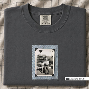 Graphite colored folded t-shirt with a small vintage photo of a father and his son sitting on the bumper of an old car.