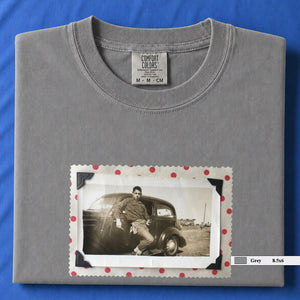Grey colored folded t-shirt with a vintage 1930's snapshot of a boy and his holster in front of an old car.
