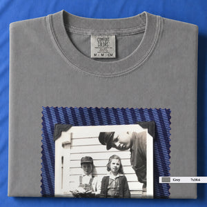 Grey colored folded t-shirt with large black and white vintage 1920's photo of kids posing for a shot