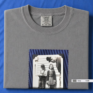 Grey colored folded t-shirt with small black and white vintage 1920's photo of kids posing for a shot