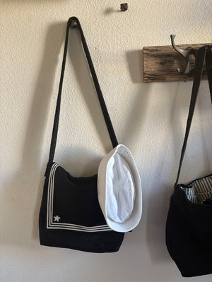 Hand made sailor bag hanging with a sailor hat.