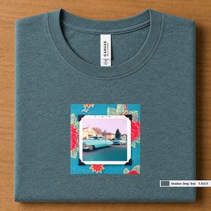 Heather Deep Teal colored folded t-shirt with a vintage photo of two classic 50's cars on the street. Photo is surrounded by floral fabric.