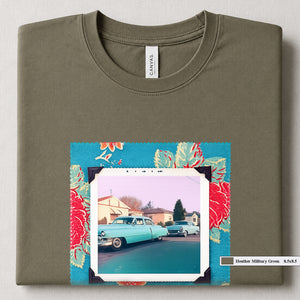Heather Military Green colored folded t-shirt with large a vintage photo of two classic 50's cars on the street. Photo is surrounded by floral fabric.