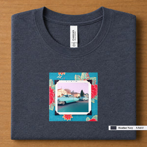 Heather Navy colored folded t-shirt with a vintage photo of two classic 50's cars on the street. Photo is surrounded by floral fabric.