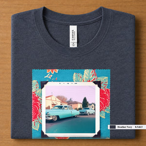 Heather Navy colored folded t-shirt with large a vintage photo of two classic 50's cars on the street. Photo is surrounded by floral fabric.