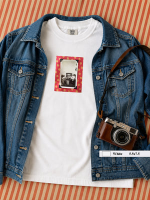 A jean jacket shown with a t-shirt and small vintage photo of musicians on front. 