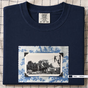Navy folded tshirt with large vintage photo of kids playing in trees on front of shirt