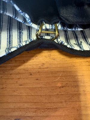 Detail of closure of vintage navy pants bag.