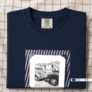 Navy t-shirt with a large vintage photo of mechanics and cars on front of shirt.