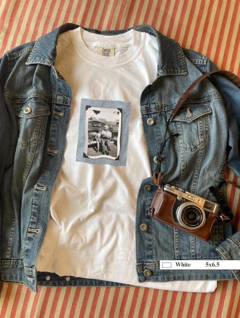 Jean jacket and white t-shirt with a vintage photo of a boy and his son sitting on the bumper of an old car.