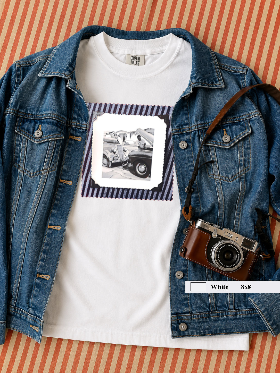 A white  t-shirt with a vintage photo of two guys fixing old trucks