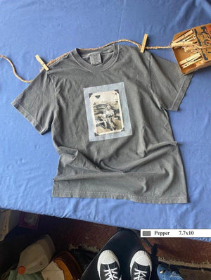 Grey t-shirt with large vintage photo of a boy and his son sitting on the bumper of an old car