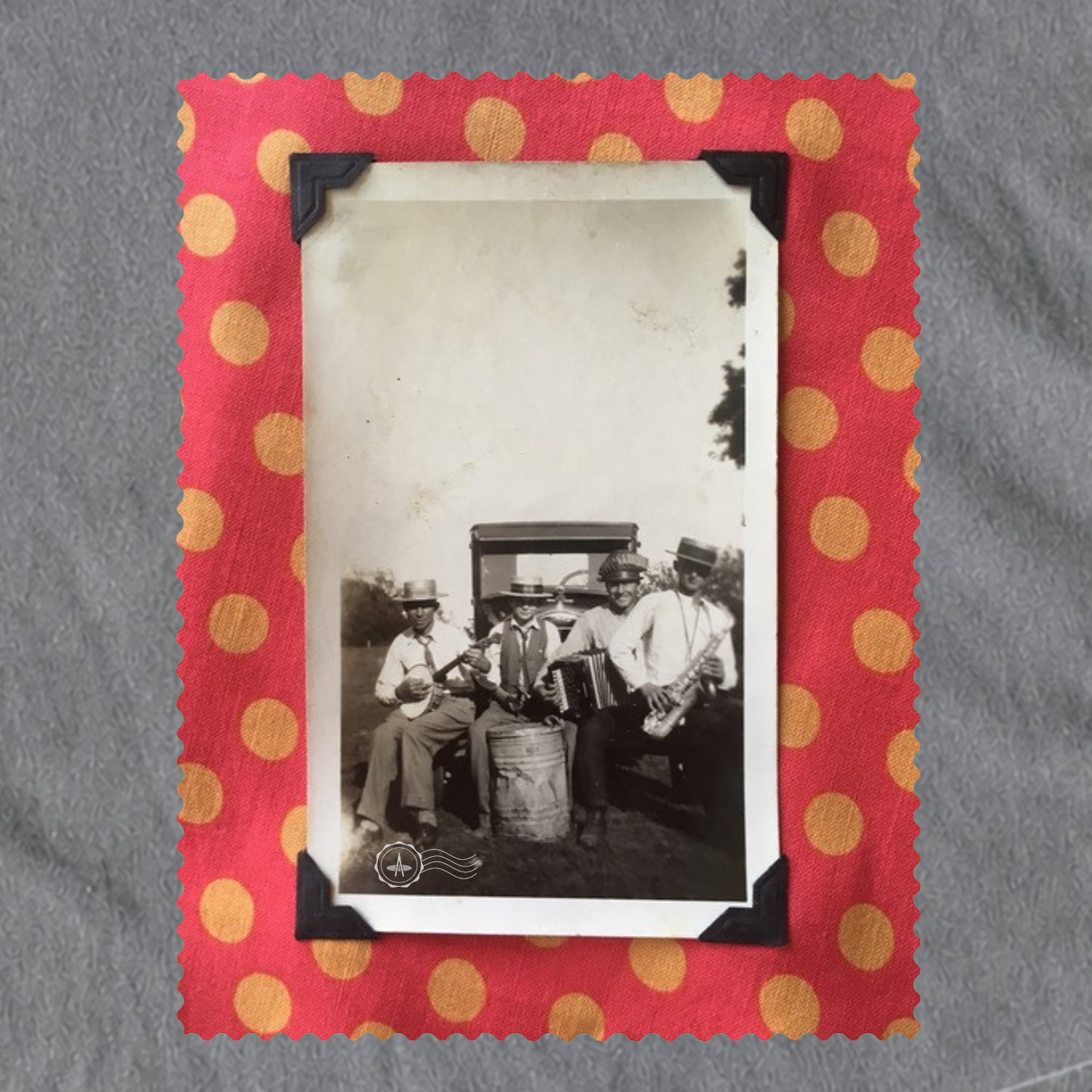 A grey colored t-shirt with small vintage music-inspired snapshot artwork