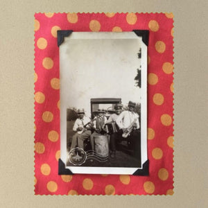 Vintage photo of a musical band on a patch of polka dot orange fabric