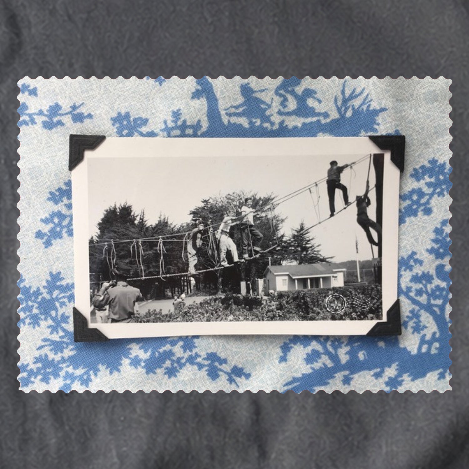 Grey t-shirt on table with small vintage photo of kids playing on front.