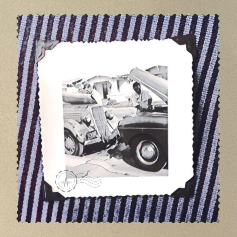 A grey t-shirt with a vintage photo of two guys fixing old trucks