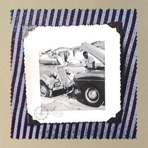 Patch of a vintage 1950's photo of two guys working on old trucks.