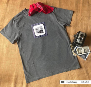 A grey t-shirt with a vintage photo of two guys fixing old trucks