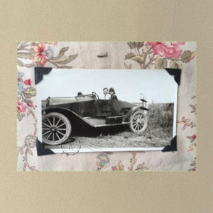 Vintage snapshot of people riding in a 1920's car surrounded with rose print 