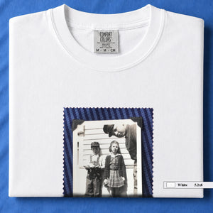 White colored folded t-shirt with small black and white vintage 1920's photo of kids posing for a shot