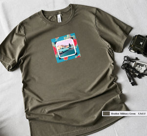 A t-shirt with a patch on the front of a vintage photo of two classic 50's cars framed in a floral fabric.