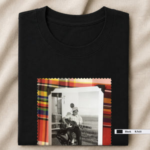 black folded tee shirt with vintage photo of guitar player on front
