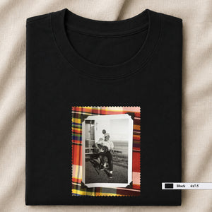 black folded tee shirt with vintage small photo of guitar player on front