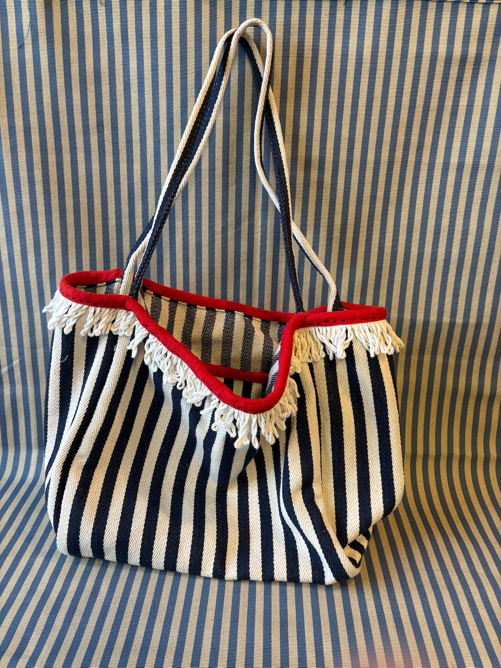 navy and white striped bag hanging 