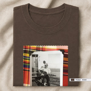 brown folded tee shirt with large vintage photo of guitar player on front