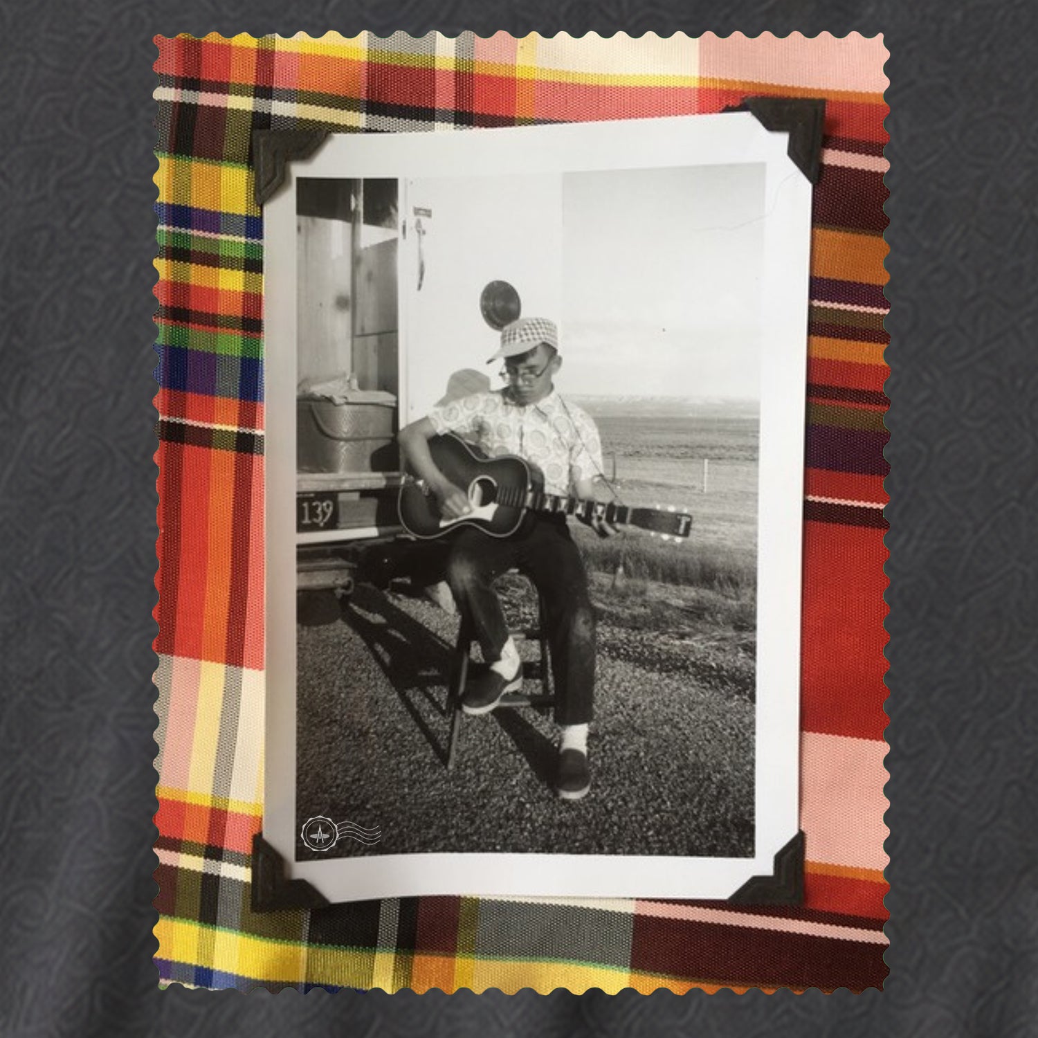 grey tee shirt with coat and small vintage photo of guitar player