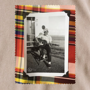 black and white vintage photo of guitar player framed in colorful plaid border