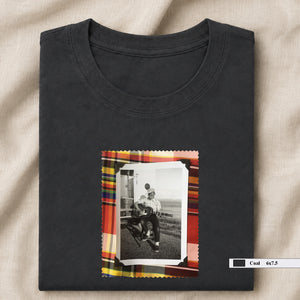 dark grey folded tee shirt with small vintage photo of guitar player on front
