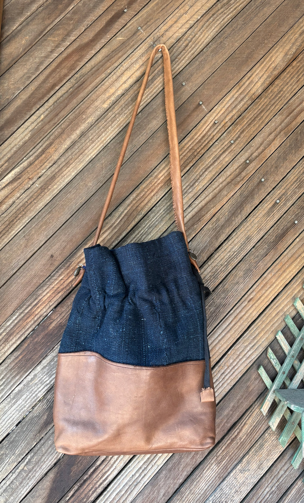 Indigo cotton and leather cinsh bag front view