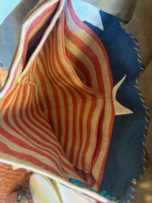 Interior of army tent bag showing striped red and ecru linen pockets