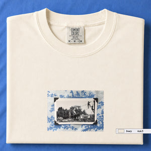 Ivory colored folded tshirt with small vintage photo of kids playing in trees on front of shirt