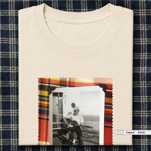 ivory folded tee shirt with large vintage photo of guitar player on front